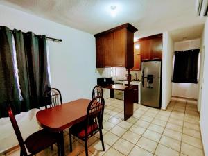 a kitchen with a wooden table and a kitchen with a table and chairs at Casa Norte in La Paz