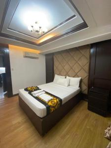 a bedroom with a bed with a coffered ceiling at Deluxe Room in Angeles