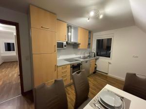 a kitchen with a table and chairs in a room at Komfortable Wohnung in Alzenau