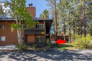a house with a red arrow in front of it at Cozy Cabin-Style Condo in Central Location in Mammoth Lakes