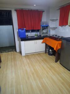 a kitchen with a counter and a table in a room at Visita highland Inn in Baguio