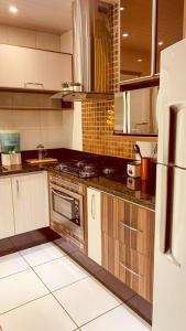 a kitchen with a stove and a refrigerator at Casa grande em bairro tranquilo in Pato Branco