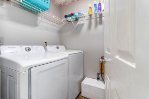 a small laundry room with a washer and dryer at Bobby's Attached Home in Monroe in Monroe