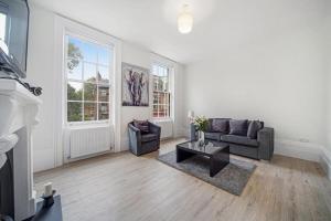 a living room with a couch and a table at Large 2 Bed Apartment London Camberwell Champion Park Denmark Hill - Great For Long Stays in London