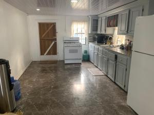 a kitchen with a white stove and a refrigerator at Vacation home rental in Georgetown