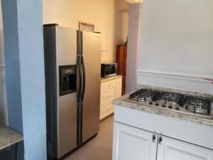a kitchen with a stainless steel refrigerator and a stove at The Seahorse Apt - Lakeside and Close to the Beach in Galveston