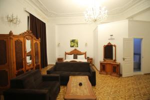 sala de estar con sofá y cama en Malakan Boutique Nizami Hotel en Bakú