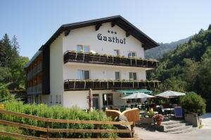 a building with a lot of chairs in front of it at Gasthof Pension Leitner in Wildbad Einöd