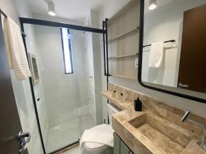 a bathroom with a shower and a sink and a toilet at Bela Hospedagem - #Sunrise 204 in João Pessoa