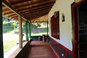 un porche de una casa con techo de madera en Alojamiento Rural Café Yarumo, en Buenavista