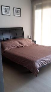 a large bed in a bedroom with a large window at Casa Provenza Bucaramanga in Bucaramanga