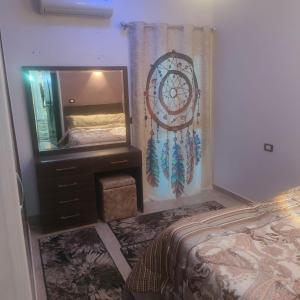 a bedroom with a bed and a large mirror at Hurghada Sea View Apartment in Hurghada