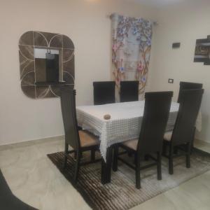 a dining room with a table and four chairs at Hurghada Sea View Apartment in Hurghada
