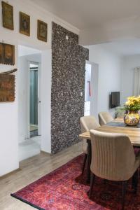 a dining room with a table and chairs and a stone wall at Mia apt. in Izmir