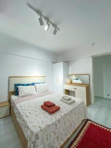 a bedroom with a large bed with two towels on it at Mia apt. in İzmir