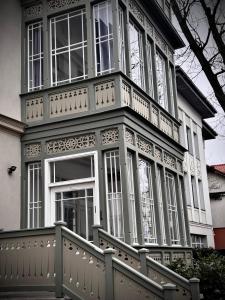 a large white house with a porch and stairs at Sopot Special Apartments in Sopot