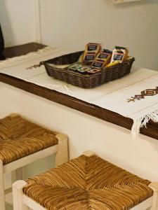 a counter with a table with a basket on top at Errika's Sweet Home in Provatas