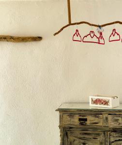 a branch hanging from a wall next to a table at Errika's Sweet Home in Provatas