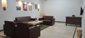 a living room with two couches and a table at AIRWAYS B&B Islamabad Free Airport Pick and Drop in Islamabad
