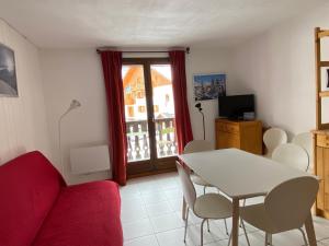 een woonkamer met een tafel en stoelen en een raam bij Appartement Valloire, 2 pièces, 4 personnes - FR-1-263-422 in Valloire