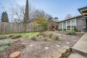 a home with a garden in front of a fence at Pacheco Studio Cottage, 22 Mi to Downtown Oakland 