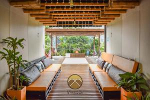 a hallway with benches and plants in a building at Casa Mochila in Salento