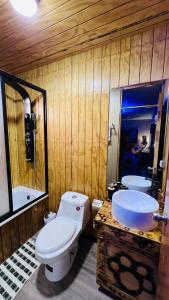 a bathroom with a toilet and a sink at Paradise Rose’s in Talagante