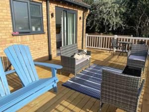 a dog laying on a chair on a deck at Binks Bungalow in Hunstanton +11 photos