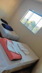 מיטה או מיטות בחדר ב-Pousada Apucarana