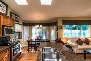 una cucina e un soggiorno con divano e tavolo di Ocean Trails Resort a Parksville