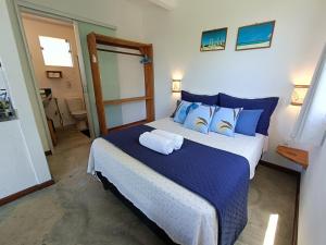 a bedroom with a large bed with blue pillows at Vila Boa Vista Itacaré in Itacaré +52 photos