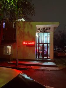 a masero store with a neon sign in front of it at Hotel MARSO in Almaty