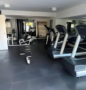 a gym with several treadmills and elliptical machines at Studio Moderno Amoblado en Puerto Madero in Buenos Aires