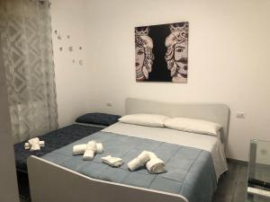 a bedroom with a bed with two towels on it at La Ginestra in Giardini Naxos