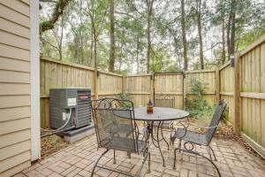 a patio with a table and chairs next to a fence at Beaufort Home with Patio 3 Mi to Downtown! in Beaufort