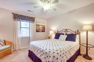 a bedroom with a bed and a ceiling fan at Beaufort Home with Patio 3 Mi to Downtown! in Beaufort