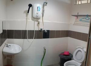 a bathroom with a shower and a toilet and a sink at Homestay Othman Perlis-14pax-AC-Wifi-Kangar-BBQ in Kangar +17 photos