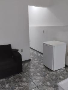 a living room with a couch and a trash can at Fine Guest in Belo Horizonte