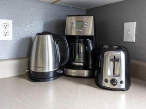 two coffee machines sitting on a counter next to each other at Ho'onani Pua Hale in Waipahu