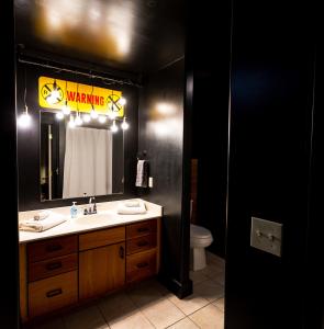 斯普林菲爾德的住宿－The C-Street Archive，浴室设有水槽和带警告标志的镜子