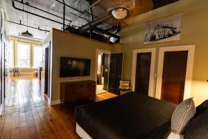 a bedroom with a bed and a flat screen tv at The C-Street Archive in Springfield