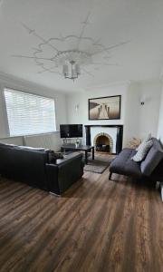 a living room with a couch and a fireplace at The Crescent, 3 bed house with 2-3 parking spaces, great for contractors and family in Kent
