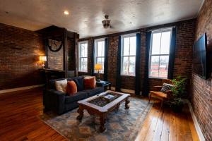 a living room with a couch and a coffee table at The Two Story Loft in Springfield