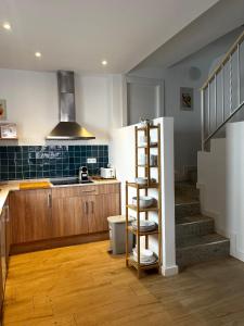 a kitchen with a staircase and a kitchen with a stair case at Regimiento 2, center, new, quite, breakfast included, parking on request, RG in Málaga