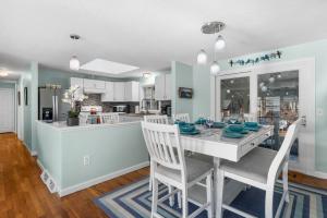 a kitchen and dining room with a table and chairs at 14 Quail Nest Run Harwich Cape Cod - Hawksnest Hideaway in Harwich