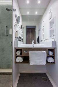 a bathroom with a sink and a shower at Park Inn By Radisson Wismar in Wismar