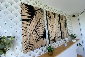 a wall with three mirrors in a room at Aesthetics - 2 bedrooms and secure parking! in Montpellier