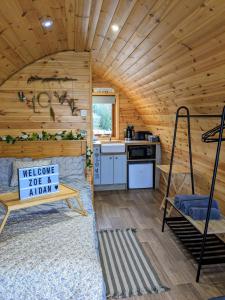 a log cabin with a bed and a kitchen at Sea Crest Pods in Rossnowlagh