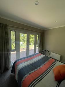a bedroom with a bed and a large window at Guest Wing in Richmond Downs in Walton