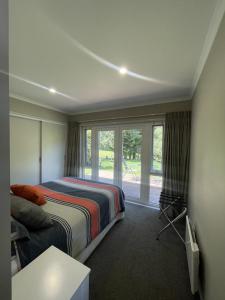 a bedroom with a bed and a window at Guest Wing in Richmond Downs in Walton